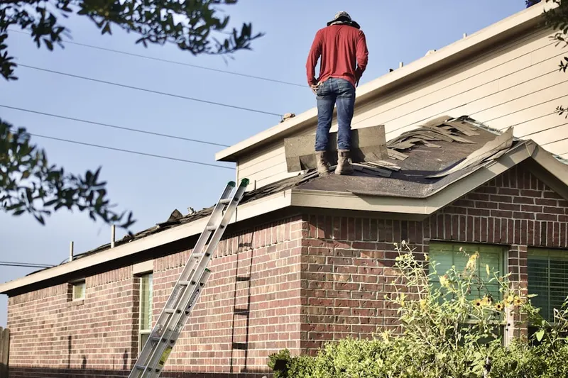 Professional roofer working on a residential roof in Lower Gwynedd